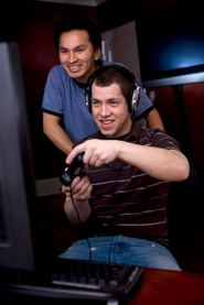 Young men playing video games on desktop PC