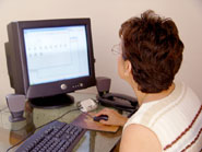 Woman using wireless desktop computer at home